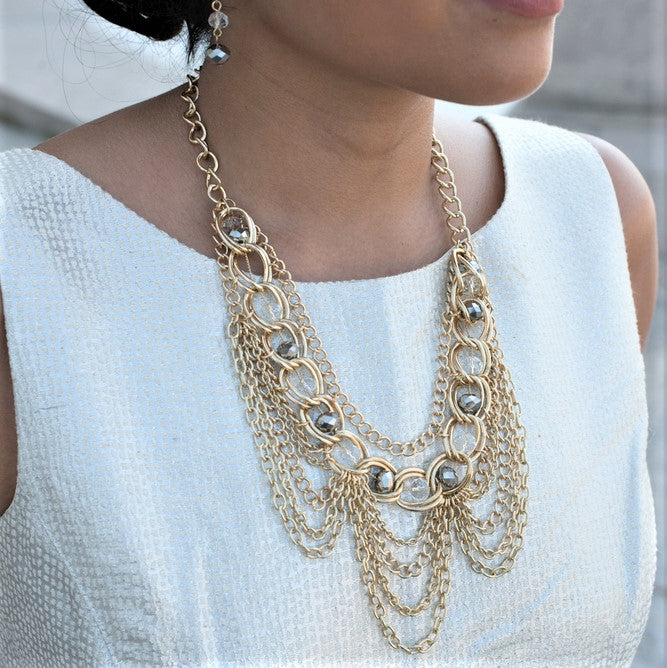 Elegant Gold Tone Crystal Bib Statement Necklace with Draped Chains and Matching Earrings