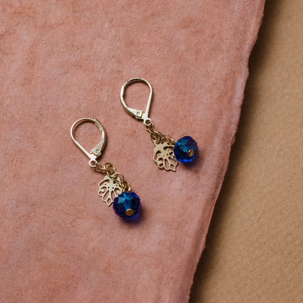 Elegant Blue Crystal Drop Earrings with Gold Tone Leaf Charm and Lever Back Closure
