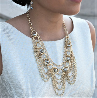 Elegant Gold Tone Crystal Bib Statement Necklace with Draped Chains and Matching Earrings