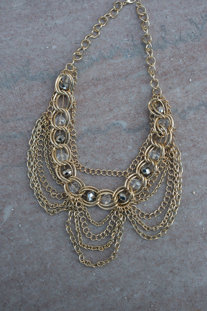 Elegant Gold Tone Crystal Bib Statement Necklace with Draped Chains and Matching Earrings