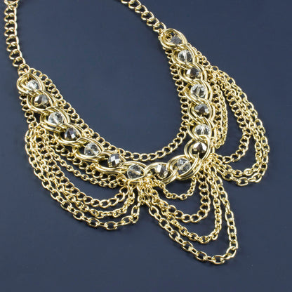 Elegant Gold Tone Crystal Bib Statement Necklace with Draped Chains and Matching Earrings